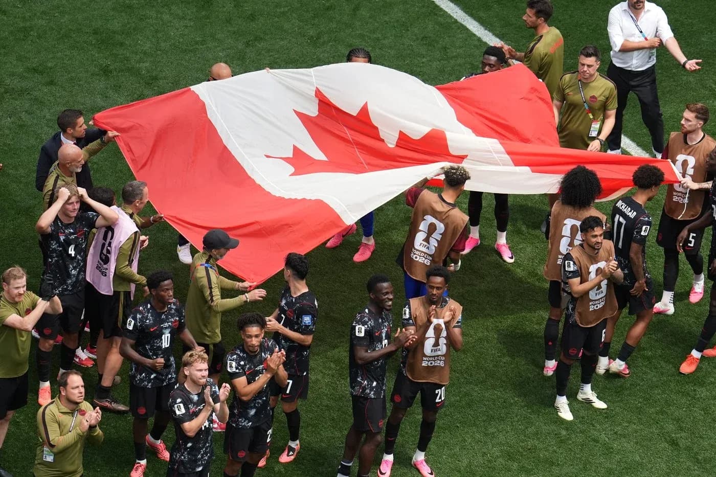 Jugadores de Canadá sosteniendo la bandera nacional