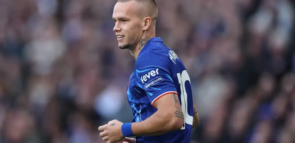 Jugador de fútbol con camiseta azul en el campo