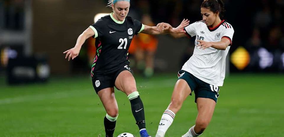 Jugadora de México intenta quitar balón a rival