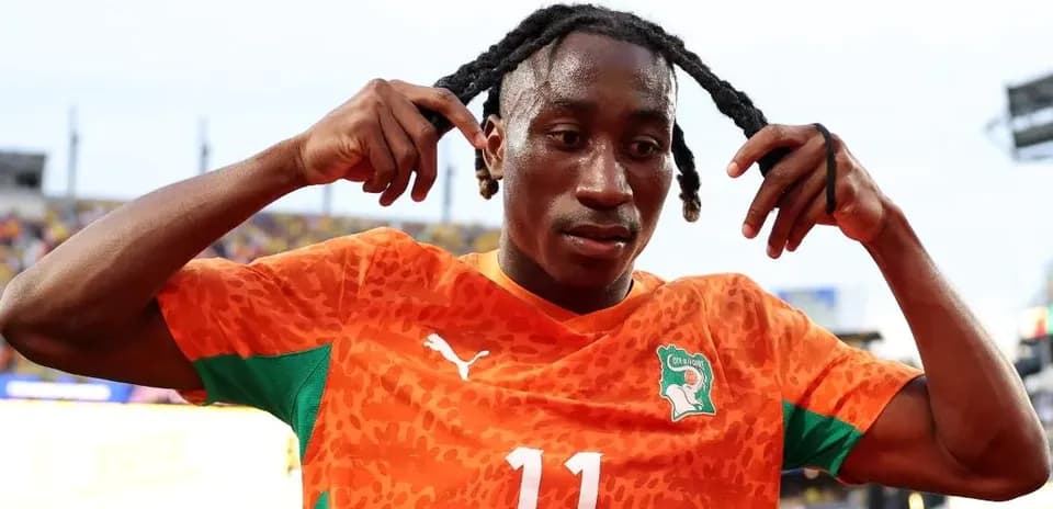 Jugador con camiseta naranja ajustándose el cabello