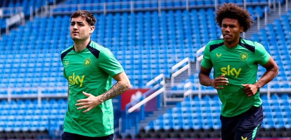 Jugadores entrenando en el estadio con camisetas verdes