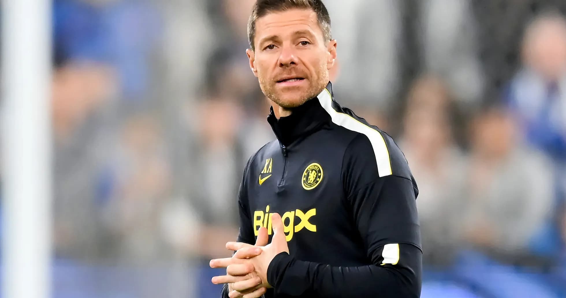 Entrenador de pie durante un partido de fútbol