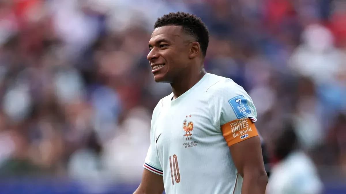 Jugador de Francia con camiseta clara sonriendo en el campo