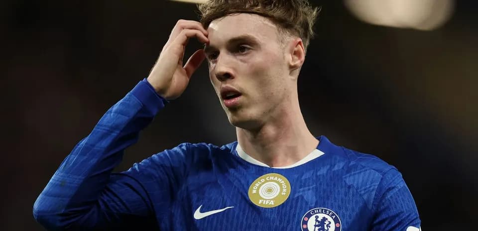 Jugador de Chelsea tocándose la cabeza en el campo