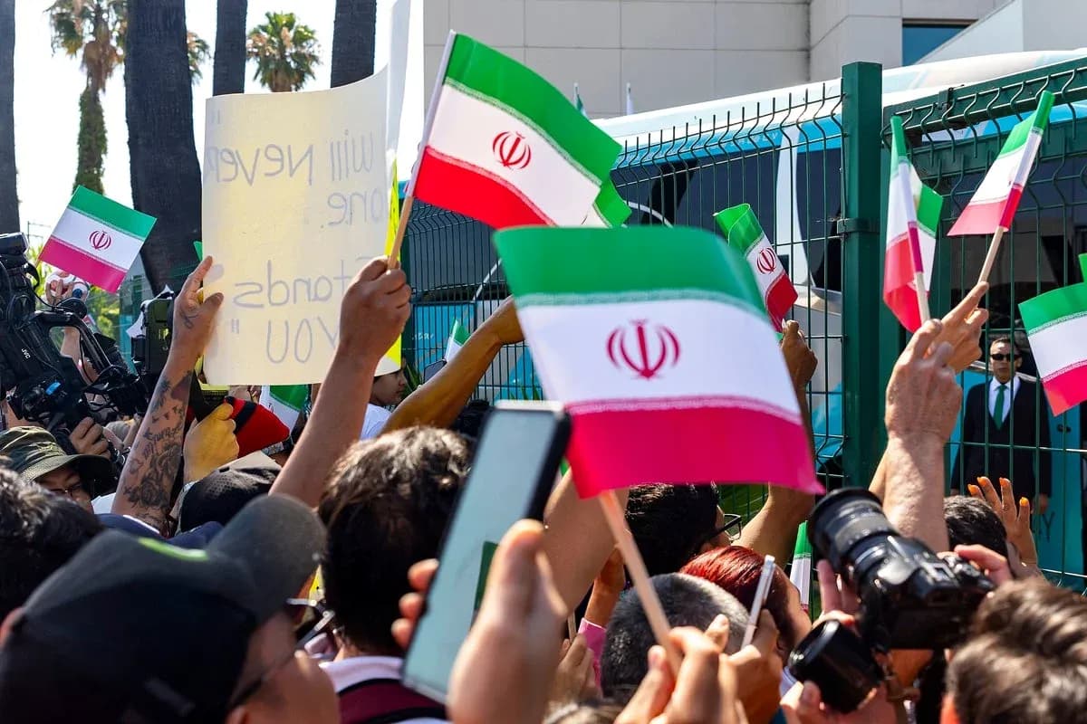 Protesters holding Iranian flags and signs Protesters holding Iranian flags and signs